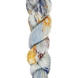 A skein of hand-dyed fingering/sock yarn color gray and orange blue speckles