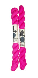 Two mini skeins of wool yarn hand dyed in Wyoming in the color pink
