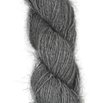 A skein of handspun angora and merino yarn in  natural grey color