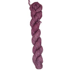 A skein of dark pink tone yarn on a white background