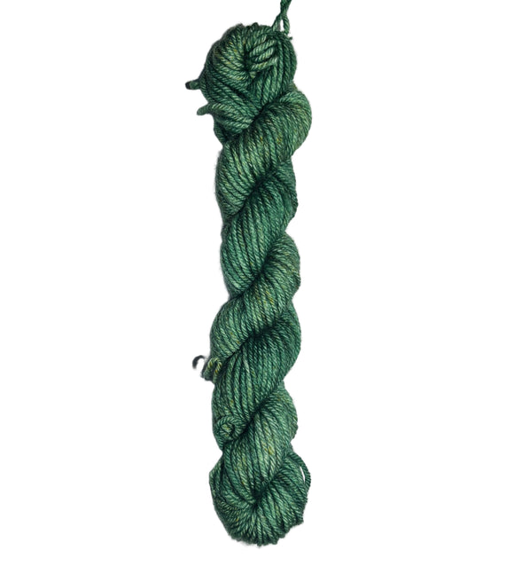 Green skein of wool yarn on a white background