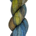 Skein of hand dyed yarn in the colors yellow black blue white brown 