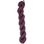 A skein of burgundy colored yarn on a white background