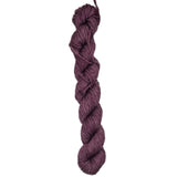 A skein of burgundy colored yarn on a white background