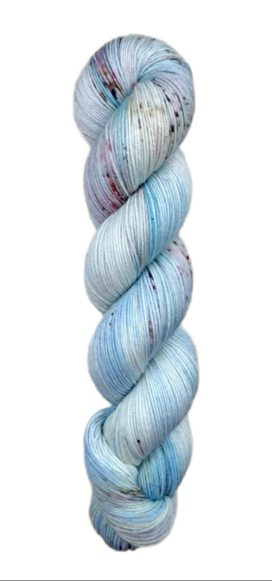 A skein of hand-dyed fingering/sock yarn color white blue grey red speckles