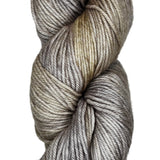 A skein of wool yarn in the color grey with khaki streaks