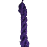 Purple skein of wool yarn on a white background