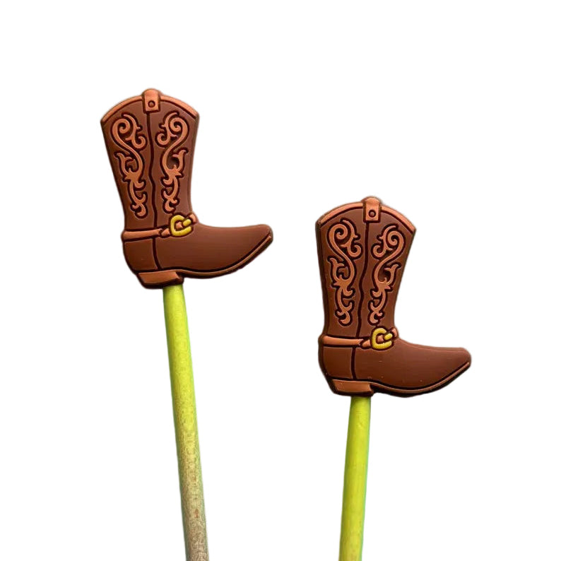Two decorative stitch stoppers shaped like cowboy boots on wookden needles