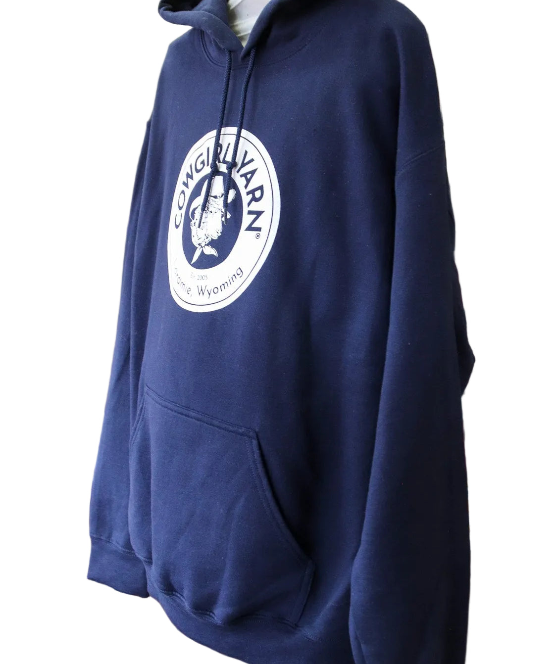 Side profile of a dark blue hoodie with the Cowgirl Yarn logo on it