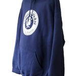 Side profile of a dark blue hoodie with the Cowgirl Yarn logo on it