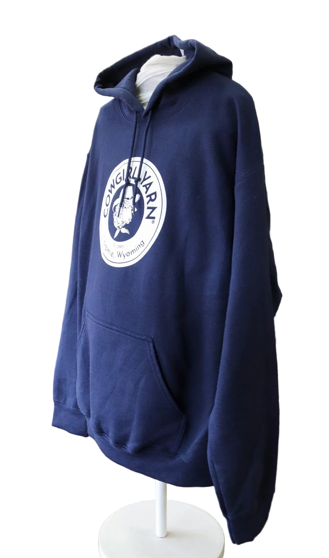 Side profile of a dark blue hoodie with the Cowgirl Yarn logo on it