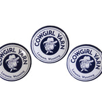3 pin buttons with the Cowgirl Yarn logos on them