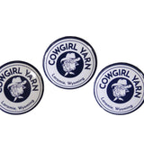 3 pin buttons with the Cowgirl Yarn logos on them