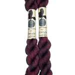 two mini skeins of yarn in a dark wine color