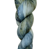 A skein of hand-dyed fingering/sock yarn color grey blue black speckles