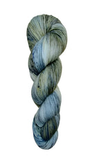 A skein of hand-dyed fingering/sock yarn color grey blue black speckles