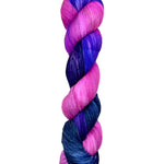 A skein of hand-dyed fingering/sock yarn color pink blue purple 