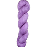 Purple skein of yarn on a light wooden surface