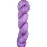 Purple skein of yarn on a light wooden surface
