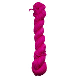 Braided pink yarn on a white background
