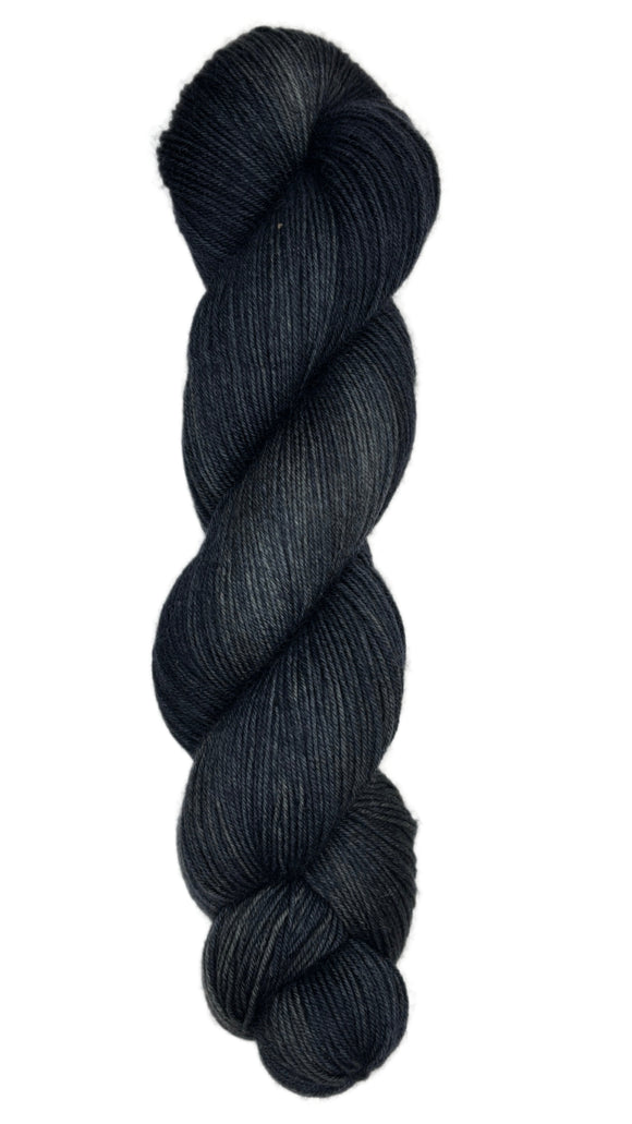 Skein of hand dyed fingering weight yarn in the color black