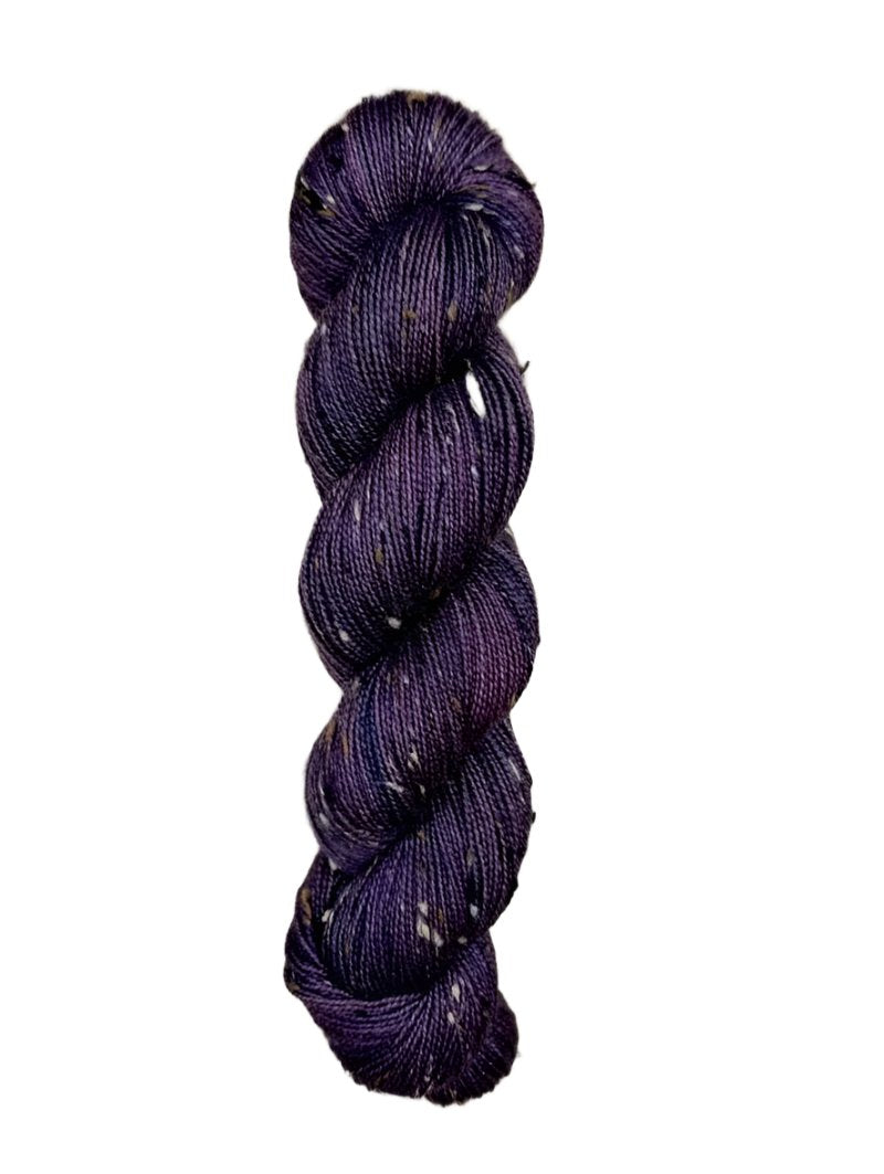 Skein of hand dyed BFL Tweed Yarn color deep purple