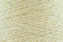Close-up of Gold White, a white base yarn with gold sparkles