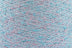 Close-up of Pink-Blue White, a white base yarn with light pink and blue sparkles