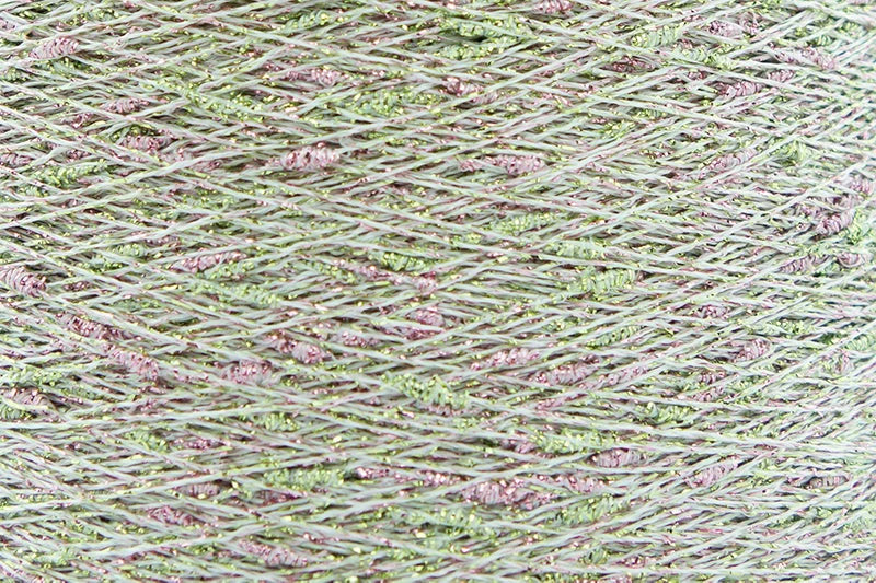 Close-up of Green-Pink White, a white base yarn with light green and pink sparkles