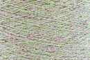 Close-up of Green-Pink White, a white base yarn with light green and pink sparkles