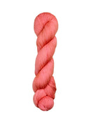 A skein of hand-dyed fingering/sock yarn color salmon pink