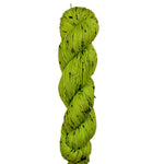 Green skein of yarn on a wooden surface