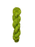 Green skein of yarn on a wooden surface