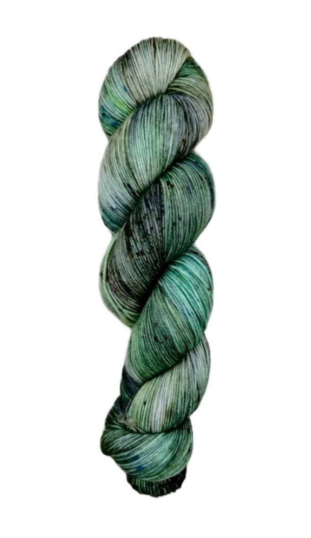 A skein of hand-dyed fingering/sock yarn color grey green black speckles