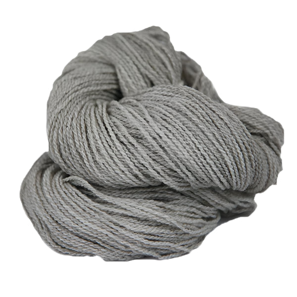 Light grey skein of fingering weight wool yarn 