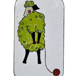 Small rectangular tin with a cartoon design of a sheep with some yarn on a white background