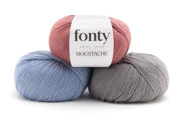Balls of Fonty Moustache Fingering Weight Yarn in the colors dusty pink blue grey 