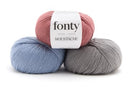 Balls of Fonty Moustache Fingering Weight Yarn in the colors dusty pink blue grey 