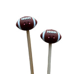 Two football-shapedstitch stoppers with smiling faces on knitting needles