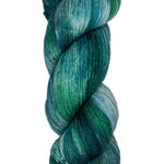 Skein of hand dyed fingering weight yarn in the color blue teal green 