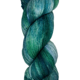 Skein of hand dyed fingering weight yarn in the color blue teal green 