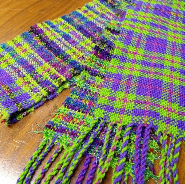 A purple and green woven scarf