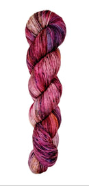 A skein of hand-dyed fingering/sock yarn color red pink blue black speckles