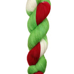 A skein of hand-dyed fingering/sock yarn color white red green