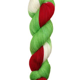 A skein of hand-dyed fingering/sock yarn color white red green