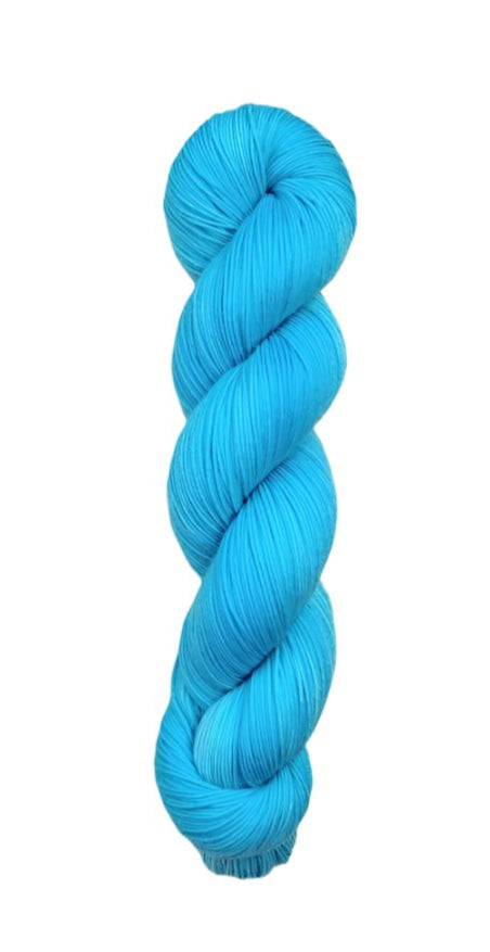 A skein of hand-dyed fingering/sock yarn color blue
