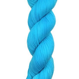A skein of hand-dyed fingering/sock yarn color blue