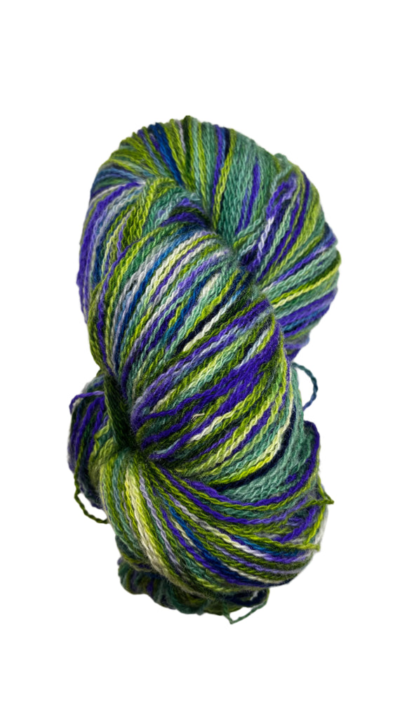 Skein of handspun yarn in the colors blue green white black