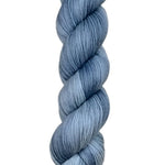 A skein of hand-dyed fingering/sock yarn color grey