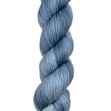 A skein of hand-dyed fingering/sock yarn color grey